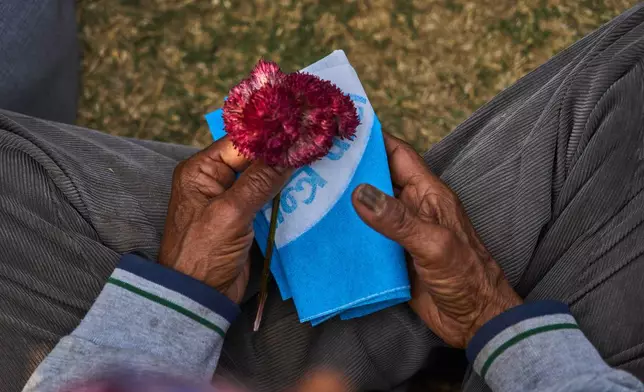A Rastriya Swatantra Party supporter waits for the arrival of prime ministerial candidate and rapper-turned-politician Balendra Shah at an election campaign rally in Chitwan, approximately 180 kilometers (112 miles) west of Kathmandu, Nepal, Friday, Feb. 27, 2026. (AP Photo/Niranjan Shrestha)