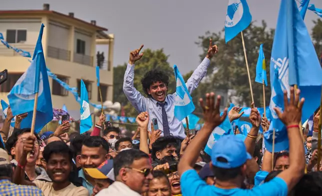 Supporters of the Rastriya Swatantra Party shout slogans as they wait for the arrival of rapper-turned-politician Balendra Shah during an election campaign rally in Chitwan, approximately 180 kilometers (112 miles) west of Kathmandu, Nepal, Friday, Feb. 27, 2026. (AP Photo/Niranjan Shrestha)