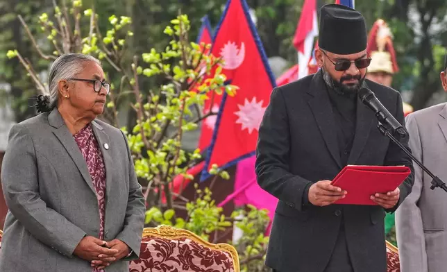 Nepal's former Chief Justice and interim Prime Minister Sushila Karki, left, watches as Nepal's youngest prime minister Balendra Shah, takes the oath of office at a function in Kathmandu, Nepal, Friday, March 27, 2026. (AP Photo/Niranjan Shrestha)