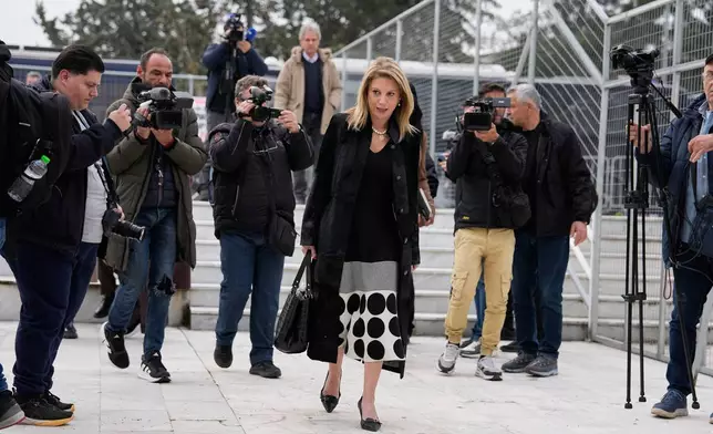 Maria Karystianou, center, mother of 21-year-old Maria-Thomai, a victim of the Tempi train crash, arrives at the court in Larissa, Greece, Monday, March 23, 2026. (AP Photo/Thanassis Stavrakis)