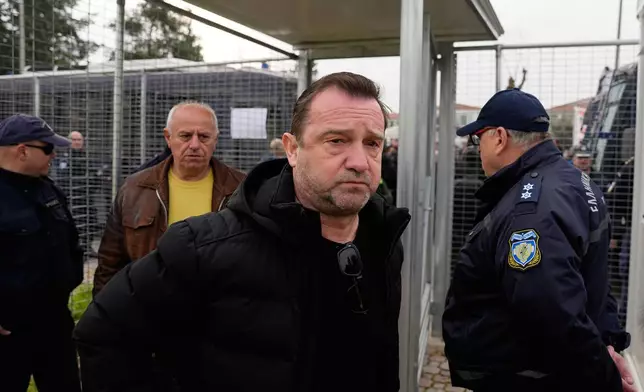 Nikos Plakias father who lost twin daughters, Thomi and Chrysa, and their cousin, Anastasia, victims of the Tempi train crash, arrive at the court in Larissa, Greece, Monday, March 23, 2026. (AP Photo/Thanassis Stavrakis)