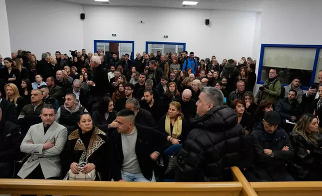 Relatives of victims of the Tempi train crash, waiting the the trial at the court in Larissa, Greece, Monday, March 23, 2026. (AP Photo/Thanassis Stavrakis)