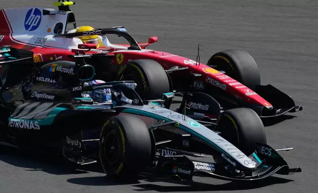 Mercedes driver George Russell, left, of Britain against Ferrari driver Lewis Hamilton of Britain during the Sprint Race of the Chinese Formula One Grand Prix at the Shanghai International Circuit, in Shanghai, China, Saturday, March 14, 2026. (AP Photo/Vincent Thian)