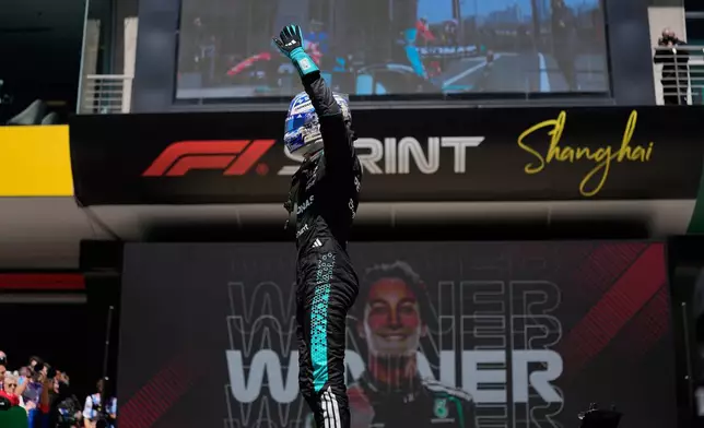 Mercedes driver George Russell of Britain waves after winning the Sprint Race of the Chinese Formula One Grand Prix at the Shanghai International Circuit, in Shanghai, China, Saturday, March 14, 2026. (AP Photo/Andy Wong)