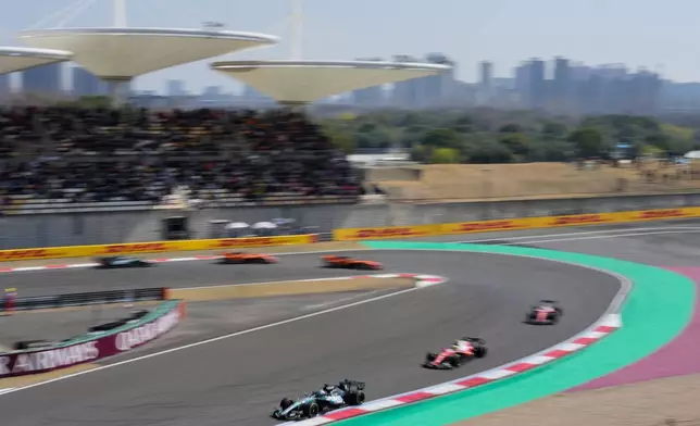 Mercedes driver George Russell, left, of Britain leads the pack during the Sprint Race of the Chinese Formula One Grand Prix at the Shanghai International Circuit, in Shanghai, China, Saturday, March 14, 2026. (AP Photo/Vincent Thian)