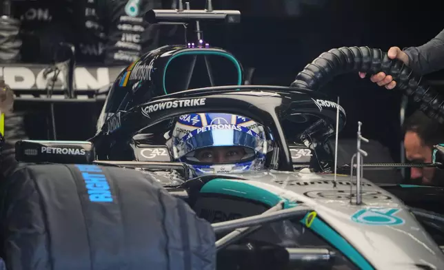 Mercedes driver George Russell of Britain sits inside his car before the start of the Sprint Race of the Chinese Formula One Grand Prix at the Shanghai International Circuit, in Shanghai, China, Saturday, March 14, 2026. (AP Photo/Andy Wong)
