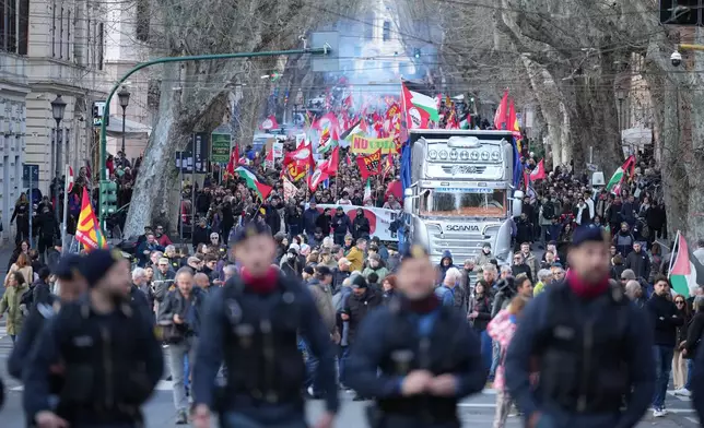 People take part in a national demonstration against the war in Iran and the March 22 referendum on the Italian justice system, in Rome, Saturday, March 14, 2026. (AP Photo/Andrew Medichini)