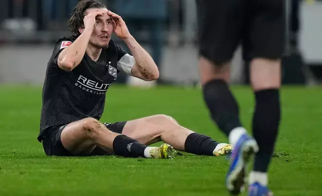 Moenchengladbach's Rocco Reitz reacts after receiving a red card during the Bundesliga soccer match between FC Bayern Munich and Borussia Moenchengladbach in Munich, Germany, March 6, 2026. (AP Photo/Matthias Schrader)