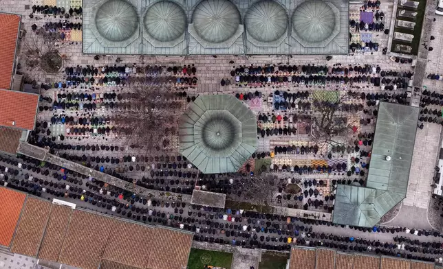 An aerial view of Bosnian Muslims praying during Eid al-Fitr, which marks the end of the holy fasting month of Ramadan in Gazi Husrev-beg Mosque in Sarajevo, Bosnia, Friday, March 20, 2026. (AP Photo/Armin Durgut)