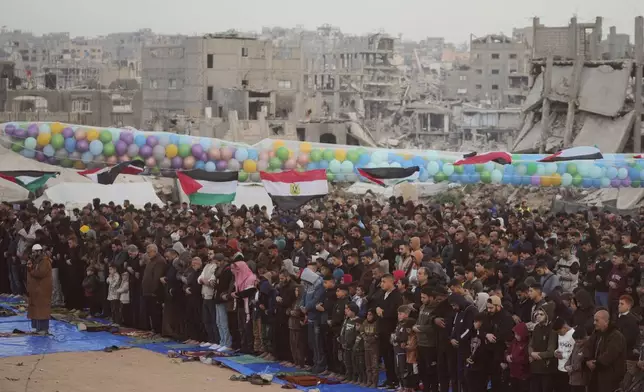 Palestinian Muslims offer Eid al-Fitr prayers amid the rubble of destroyed buildings in Jabaliya, Gaza Strip, Friday, March 20, 2026. (AP Photo/Jehad Alshrafi)