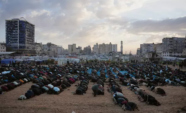 Palestinians offer Eid al-Fitr prayers in Gaza City, Friday, March 20, 2026. (AP Photo/Abdel Kareem Hana)