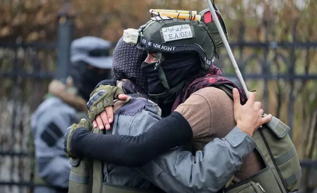 Taliban policemen, left, and a GDI ( General Directorate of Intelligence ) officer greet each other for Eid al-Fitr outside the Shah-Do Shamshira Mosque before Eid prayers in Kabul, Afghanistan, Thursday, March 19, 2026. (AP Photo/Siddiqullah Alizai)