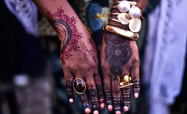 A women from Benin shows her hands, painted and decorated to celebrate Eid al-Fitr, the Muslim holiday marking the end of Ramadan, Islam's holy month of fasting, at a mosque in Berlin, Germany, Friday, March 20, 2026. (AP Photo/Markus Schreiber)