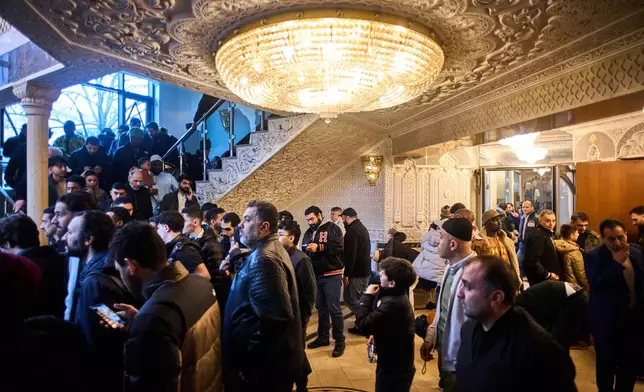 Muslims leave the Omar ibn al-Khattab Mosque after Eid al-Fitr prayers, the Muslim holiday marking the end of Ramadan, Islam's holy month of fasting, in Berlin, Germany, Friday, March 20, 2026. (AP Photo/Markus Schreiber)