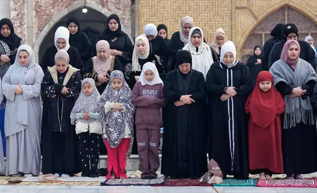 Muslims offer Eid al-Fitr prayers at the Abdul-Qadir al-Gailani mosque in Baghdad, Iraq, Friday, March 20, 2026. (AP Photo/Hadi Mizban)