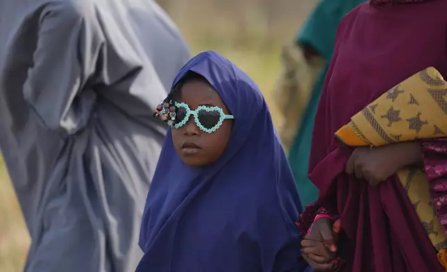 A girl arrives for Eid al-Fitr prayers, marking the end of the fasting month of Ramadan in Lagos, Nigeria, Friday, March 20, 2026. (AP Photo/Sunday Alamba)