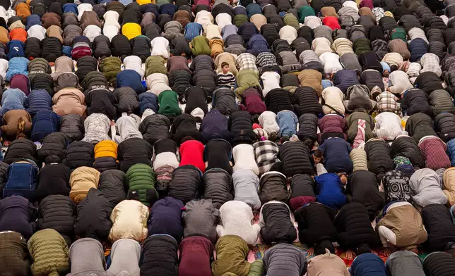 Muslims attend Eid al-Fitr prayers in a sports hall in Bucharest, Romania, Friday, March 20, 2026. (AP Photo/Vadim Ghirda)