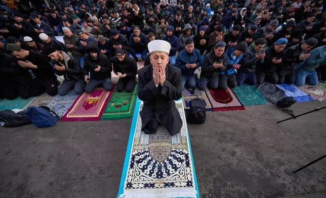 Muslims pray outside the Moscow Cathedral Mosque during celebrations of Eid al-Fitr holiday, a feast celebrated by Muslims worldwide, in Moscow, Russia, early Friday, March 20, 2026. (AP Photo/Alexander Zemlianichenko)