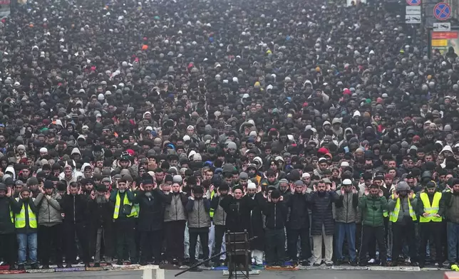 Muslims pray as they celebrate Eid al-Fitr, marking the end of the Muslims' holy fasting month of Ramadan, in St. Petersburg, Russia, Friday, March 20, 2026. (AP Photo/Dmitri Lovetsky)