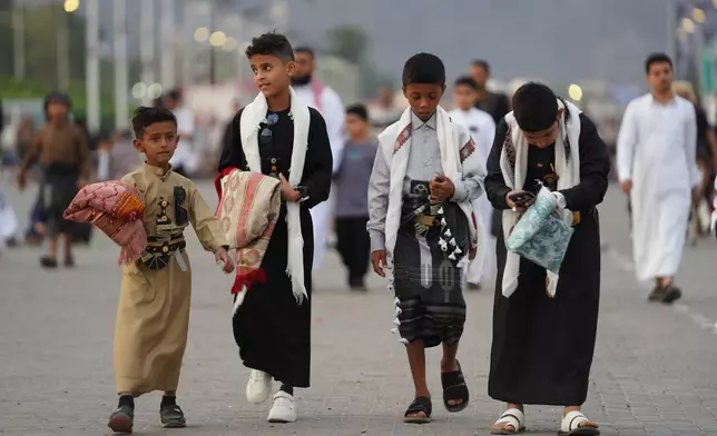 People walk to pray Eid Al-Fitr prayers, marking the feast after Ramadan, celebrating the end of fasting, in Aden, Yemen, Friday, March 20, 2026. (AP Photo/Abdulnasser Alseddik)