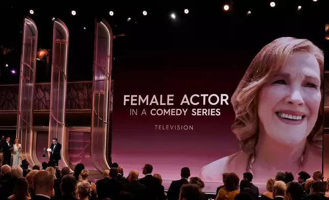 Seth Rogen accepts the award for outstanding performance by a female actor in a comedy series for "The Studio" on behalf of Catherine O'Hara during the 32nd Annual Actor Awards on Sunday, March 1, 2026, at the Shrine Auditorium and Expo Hall in Los Angeles. Lisa Kudrow looks on from left.(AP Photo/Chris Pizzello)