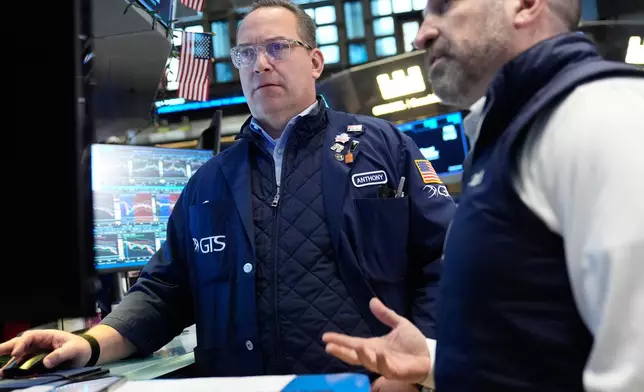 Anthony Matesic, left, and James Denaro work on the floor at the New York Stock Exchange in New York, Thursday, March 19, 2026. (AP Photo/Seth Wenig)