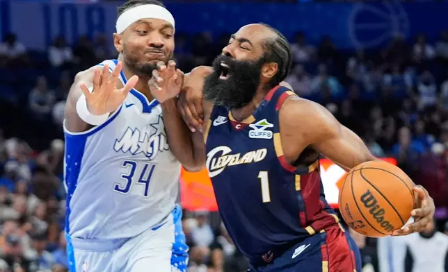 Cleveland Cavaliers guard James Harden (1) is fouled by Orlando Magic center Wendell Carter Jr. (34) as he drives to the basket during the second half of an NBA basketball game, Wednesday, March 11, 2026, in Orlando, Fla. (AP Photo/John Raoux)