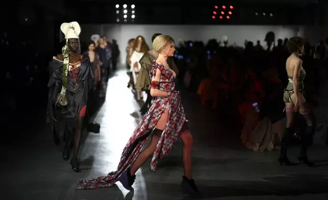 Models wear creations from the Vivienne Westwood Fall/Winter 2026-2027 Women's collection presented in Paris, Saturday, March 7, 2026. (AP Photo/Tom Nicholson)