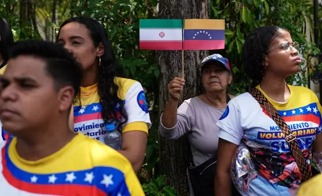 FILE - People gather outside the Iranian Embassy to protest the US-Israeli war on Iran in Caracas, Venezuela, March 3, 2026. (AP Photo/Ariana Cubillos, File)