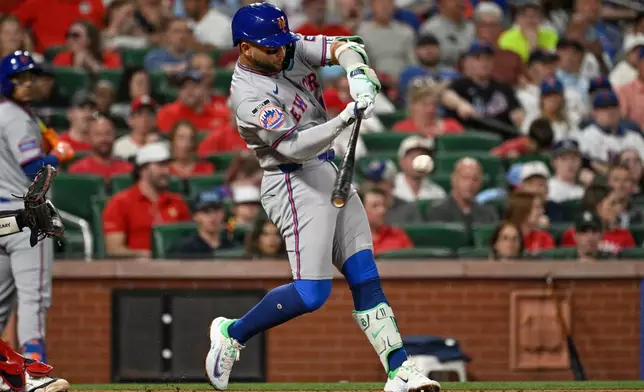 New York Mets' Bo Bichette hits an RBI single in the fifth inning of a baseball game against the St. Louis Cardinals, Monday, March 30, 2026, in St. Louis. (AP Photo/Joe Puetz)