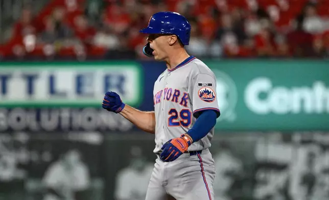 New York Mets' Jared Young celebrates after hitting an RBI double in the sixth inning of a baseball game against the St. Louis Cardinals, Monday, March 30, 2026, in St. Louis. (AP Photo/Joe Puetz)