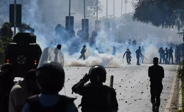 Police officers fire tear gas shells to disperse Shiite Muslims marching toward U.S. Embassy during a rally to condemn the killing of Iranian Supreme Leader Ayatollah Ali Khamenei, in Islamabad, Pakistan, Sunday, March 1, 2026. (AP Photo/M.A. Sheikh)