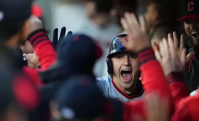 Cleveland Guardians' Chase DeLauter celebrates in the dugout after hitting a solo home run against Seattle Mariners starting pitcher Logan Gilbert during the first inning of an opening-day baseball game, Thursday, March 26, 2026, in Seattle. (AP Photo/Lindsey Wasson)