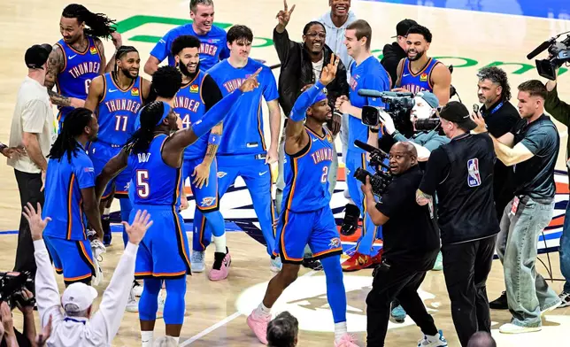 Oklahoma City Thunder guard Shai Gilgeous-Alexander (2) celebrates with teammates after the second half of an NBA basketbal against the Denver Nuggetsl game Monday, March 9, 2026, in Oklahoma City. (AP Photo/Gerald Leong)