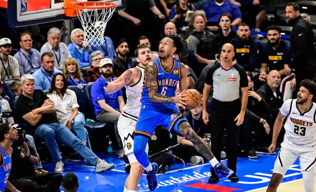 Oklahoma City Thunder forward Jaylin Williams (6) shoots against Denver Nuggets center Nikola Jokić (15) during the first half of an NBA basketball game Monday, March, 9 2026, in Oklahoma City. (AP Photo/Gerald Leong)