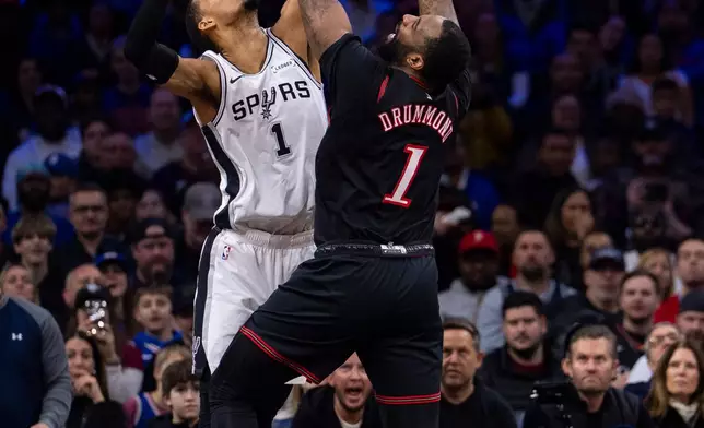 San Antonio Spurs' Victor Wembanyama, left, blocks the shot by Philadelphia 76ers' Andre Drummond during the first half of an NBA basketball game, Tuesday, March 3, 2026, in Philadelphia. (AP Photo/Chris Szagola)