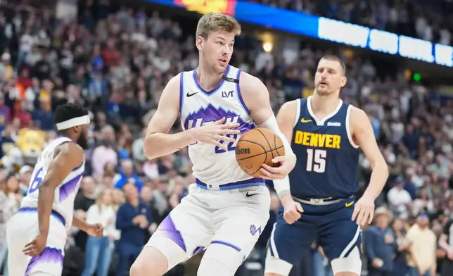 Utah Jazz center Kyle Filipowski, front, pulls in a rebound in front of Denver Nuggets center Nikola Jokić (15) in the first half of an NBA basketball game Friday, March 27, 2026, in Denver. (AP Photo/David Zalubowski)