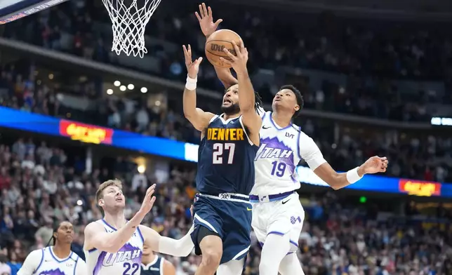 Denver Nuggets guard Jamal Murray, center, is fouled by Utah Jazz forward Ace Bailey, right, as center Kyle Filipowski defends in the first half of an NBA basketball game Friday, March 27, 2026, in Denver. (AP Photo/David Zalubowski)
