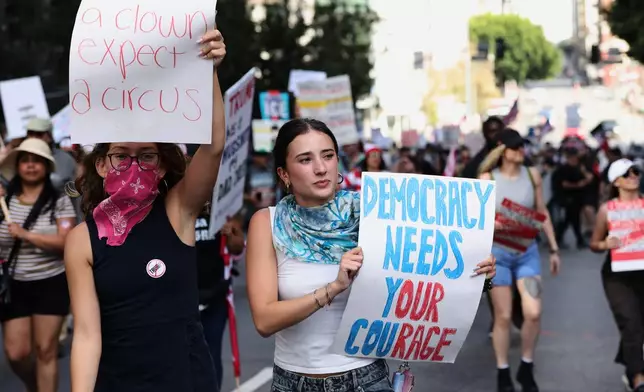 Demonstrators march through downtown Los Angeles during a "No Kings" protest Saturday, March 28, 2026. (AP Photo/Jill Connelly)