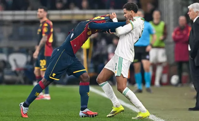 Genoa's Caleb Ekuban, left, argues with Roma's Devyne Rensch during the Italian Serie A soccer match between Genoa and Roma in Genoa, Italy, Sunday, March 8, 2026. (Tano Pecoraro/LaPresse via AP)