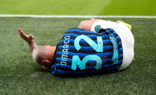 Inter Milan's Federico Dimarco lies on the pitch in pain during the Serie A soccer match between AC Milan and Inter Milan, in Milan, Italy, Sunday, March 8, 2026. (AP Photo/Luca Bruno)