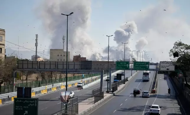 Plumes of smoke rise as strikes hit the city during the U.S.–Israeli military campaign in Tehran, Iran, Thursday, March 5, 2026. (AP Photo/Vahid Salemi)