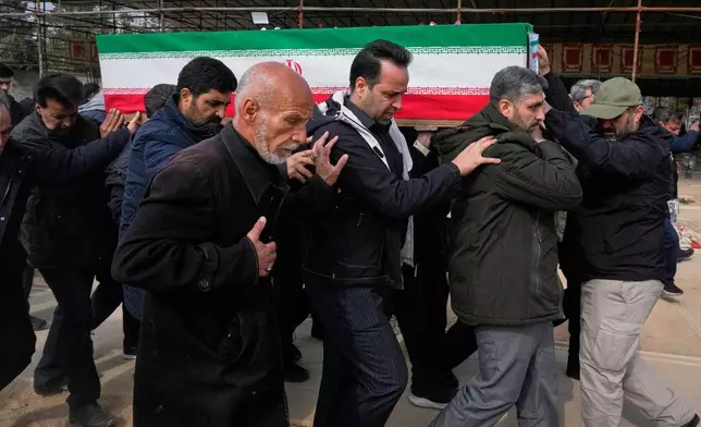 The coffin of Mehdi Hosseini, a man killed in a U.S.-Israeli strike, is carried for burial at Behesht-e Zahra cemetery in Tehran, Iran, Monday, March 9, 2026. (AP Photo/Vahid Salemi)