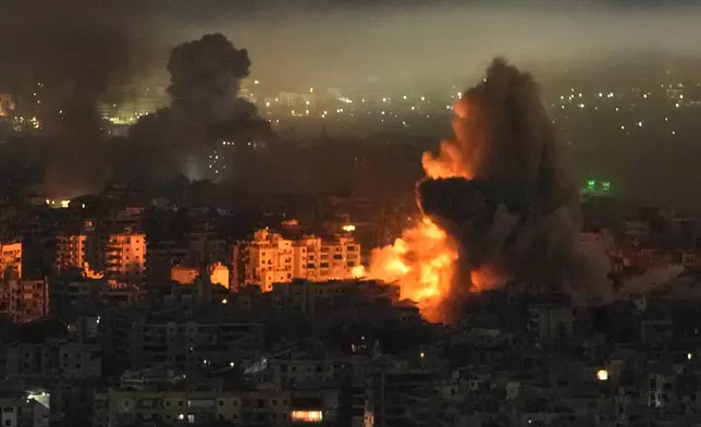 Smoke and flames rise from buildings following an Israeli airstrike in Dahiyeh, Beirut's southern suburbs, Lebanon, Wednesday, March 11, 2026. (AP Photo/Bilal Hussein)