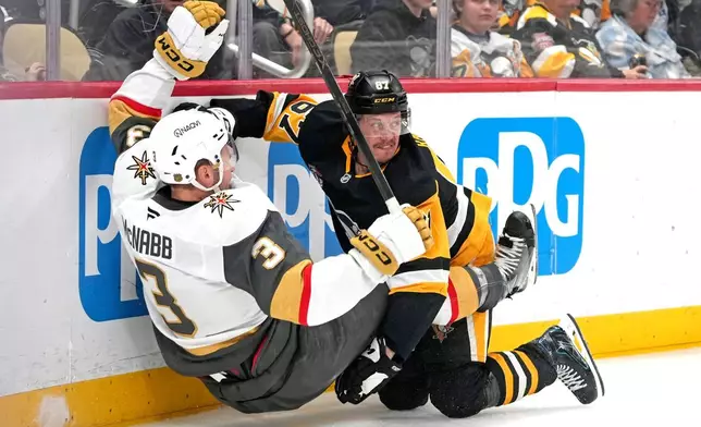 Pittsburgh Penguins' Rickard Rakell (67) collides with Vegas Golden Knights' Brayden McNabb (3) during the second period of an NHL hockey game in Pittsburgh, Sunday, March 1, 2026. (AP Photo/Gene J. Puskar)