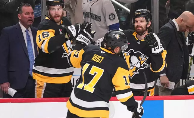 Pittsburgh Penguins' Bryan Rust (17) returns to the bench after scoring during the second period of an NHL hockey game against the Vegas Golden Knights in Pittsburgh, Sunday, March 1, 2026. (AP Photo/Gene J. Puskar)