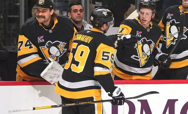 Pittsburgh Penguins' Egor Chinakhov (59) returns to the bench after scoring during the second period of an NHL hockey game against the Vegas Golden Knights in Pittsburgh, Sunday, March 1, 2026. (AP Photo/Gene J. Puskar)