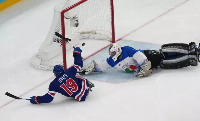 United States' Malik Jones, left, scores during the Group A hockey match between United States and Italy the 2026 Winter Paralympics, in Milan, Italy, Saturday, March 7, 2026. (AP Photo/Antonio Calanni)