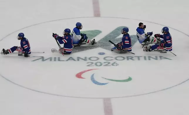 Italy and United States' players at the end of the Group A hockey match between United States' and Italy at the 2026 Winter Paralympics, in Milan, Italy, Saturday, March 7, 2026. (AP Photo/Antonio Calanni)