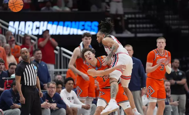 Illinois guard Keaton Wagler, left, is fouled by Houston guard Emanuel Sharp (21) during the second half in the Sweet 16 of the NCAA college basketball tournament Thursday, March 26, 2026, in Houston. (AP Photo/Eric Gay)